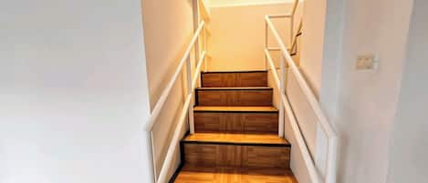 A staircase with wooden steps and white railings.