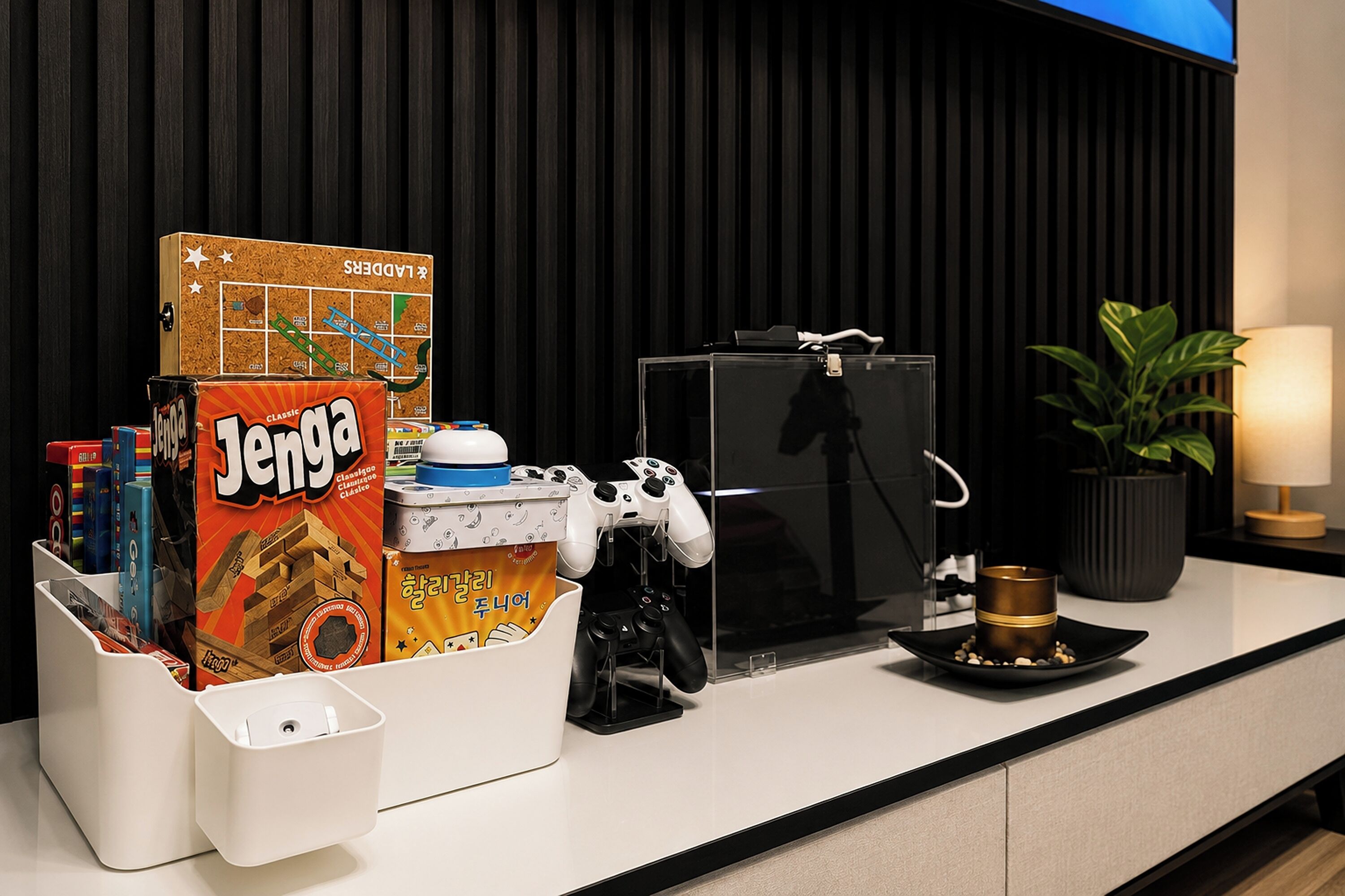 A hotel reception desk with a board game, a coffee machine, and a plant.