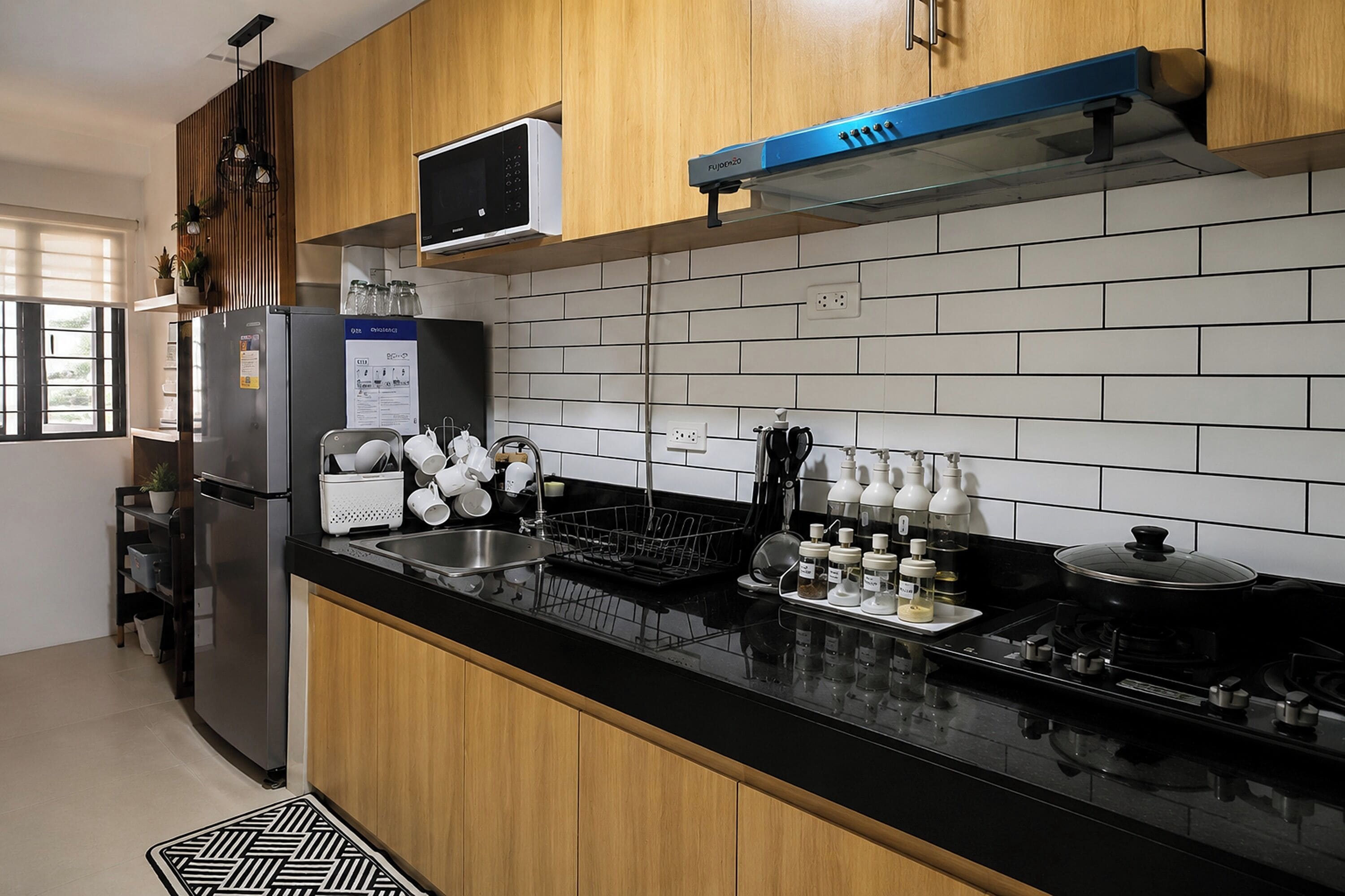 A modern kitchen with wooden cabinets, a black countertop, a built-in microwave, and a stove.