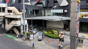 A modern building with a unique geometric facade, a covered entrance, and a landscaped area with plants. - SMDC Light Residences Condominium near Boni MRT (Mandaluyong)