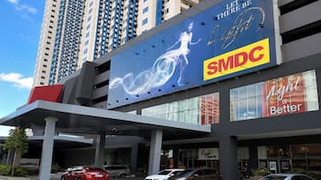 A modern building with a large billboard advertising SMDC.
