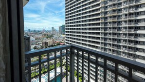 A high-rise building with multiple balconies and a view of a cityscape. - SMDC Light Residences Condominium near Boni MRT (Mandaluyong)