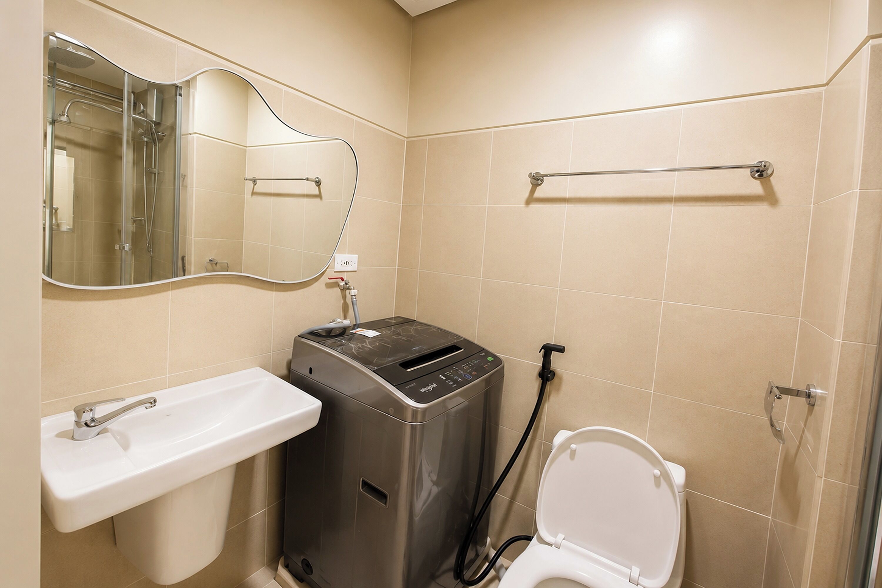 A bathroom with a sink, a toilet, a mirror, and a portable heater.
