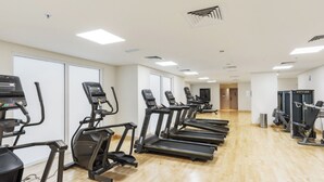 A fitness center with treadmills, stationary bikes, and weight machines.