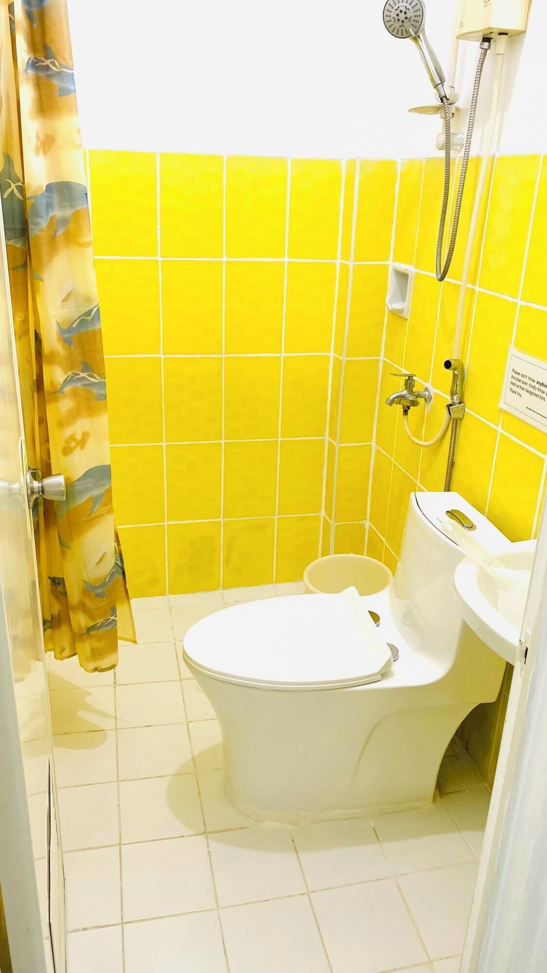 A bathroom with a bathtub, toilet, and shower.