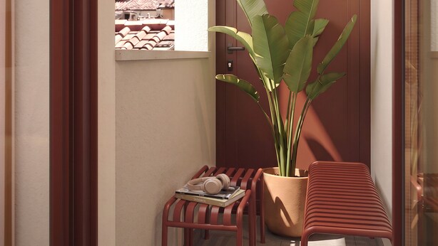 A corner with a potted plant, a small table with books and headphones, and a bench. - Numa Florence Fiesolana (Firenze)