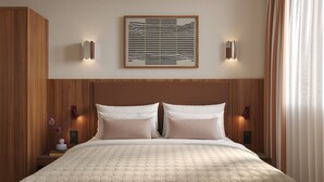 A neatly made bed with a textured quilt, a wooden headboard, and two wall-mounted lights. - Numa Florence Fiesolana (Firenze)