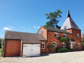 A large brick building with a prominent tower and a garage.