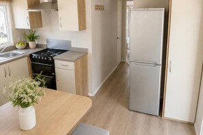 A modern kitchen with a stove, oven, and refrigerator. - Billing Aquadrome Holiday Park - 2 Bedroom, Silver (Northampton)