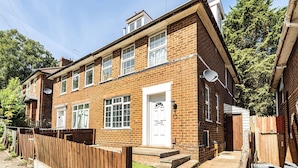 A two-story brick house with a front door, windows, and a satellite dish. - 2-br, Sleeps 4 With Garden Near Uni & Q E Hospital (Birmingham)