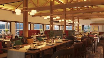 A restaurant with wooden beams, multiple tables set for dining, and large windows offering views.