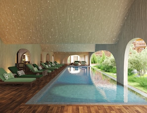 A pool area with lounge chairs and a view of a building.