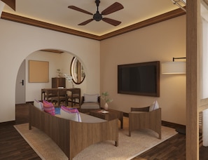 A modern living room with a central coffee table, seating area, and a ceiling fan.