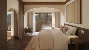 A spacious bedroom with a large bed, a bedside table, and a view of a balcony with curtains.