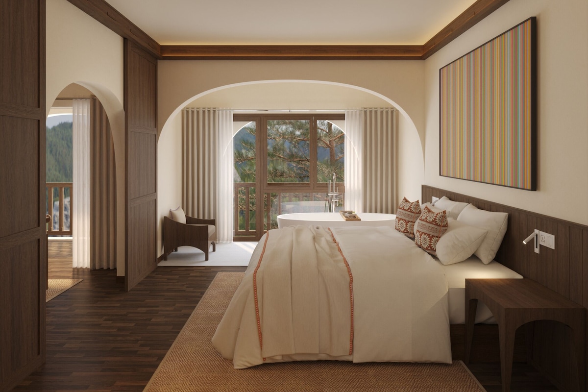 A spacious bedroom with a large bed, a bedside table, and a view of a balcony with curtains.