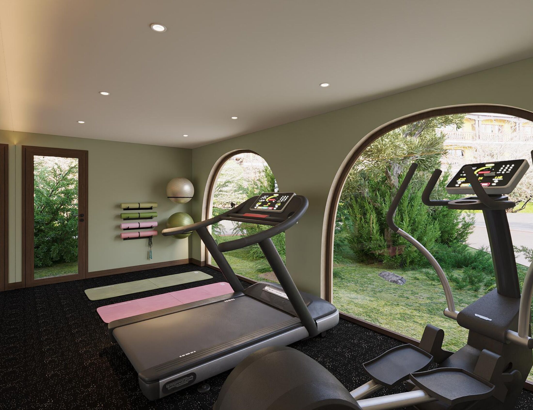 Un gimnasio con cintas de correr, una bicicleta estática y un espacio para yoga.