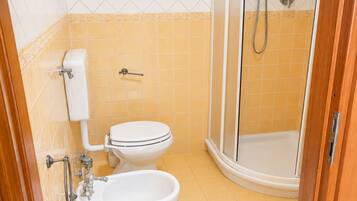 Un bagno con toilette, bidet e doccia.