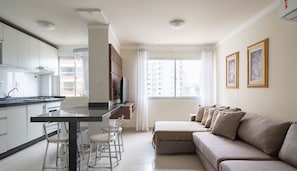 A modern kitchen with a dining area, a sofa, and a TV. - Apt 130m From Beach Balneario Camboriu-sc Eac1303 (Balneário Camboriú)