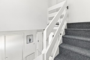 A staircase with white railings and carpeted steps leading to a door with a framed picture. - Arbour House • Sleeps 5 • Free Parking • Spacious Garden • Fast Wifi • Self-Check-In • Yoko Property (Northampton)
