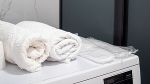 A white towel on a white appliance, possibly a dryer, with a digital display. - Comfort 1-room apartments  (Almaty)