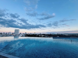 An infinity pool with a city skyline in the background.