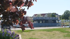 A building with a flat roof and a large window.