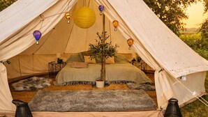 A cozy tent with a bed, a potted plant, and decorative lanterns. - Countryside Avon Escape for Two (Pewsey)
