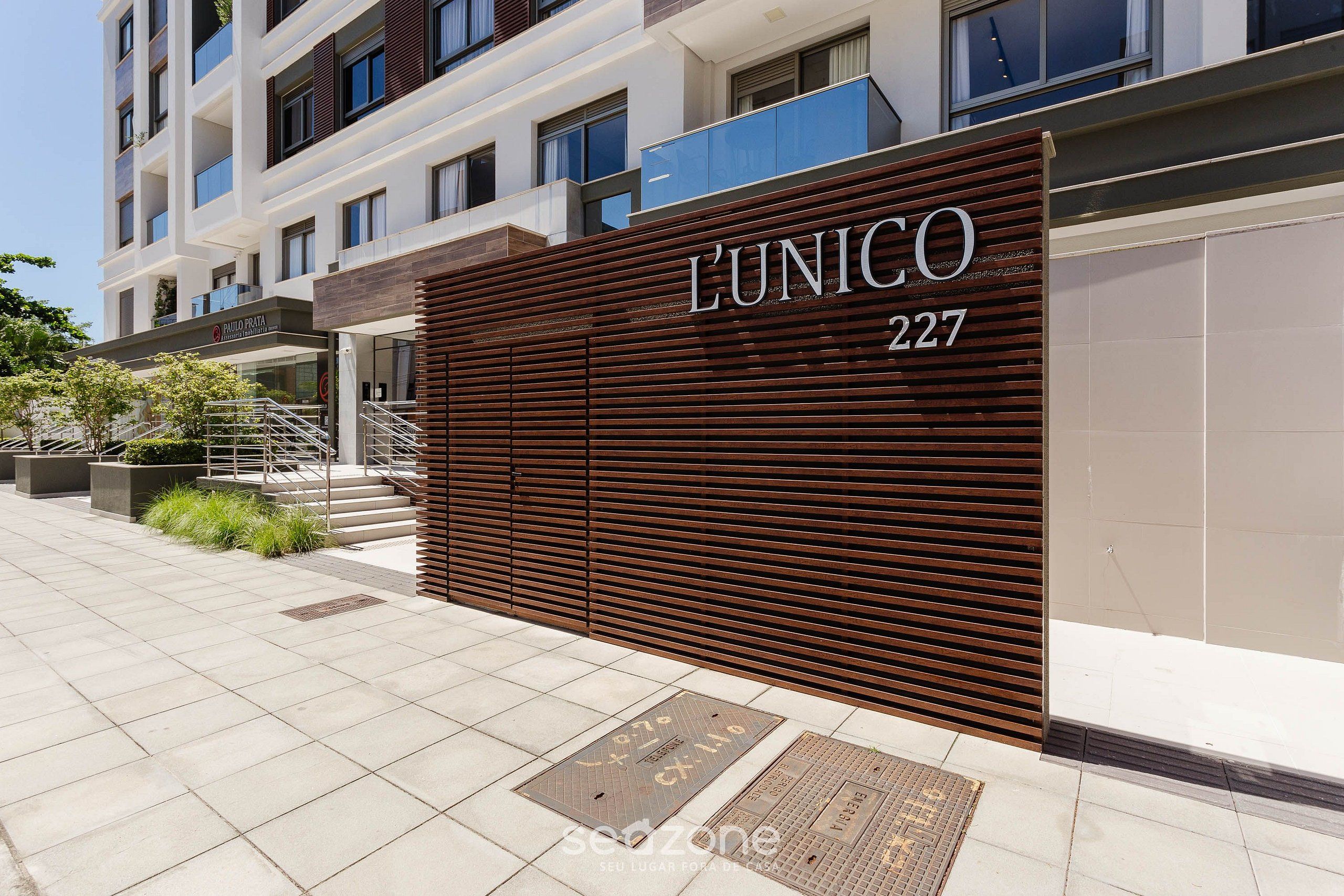 A modern building facade with a large sign reading "L'UNICO 227".