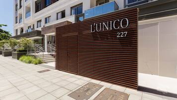 A modern building facade with a large sign reading "L'UNICO 227".