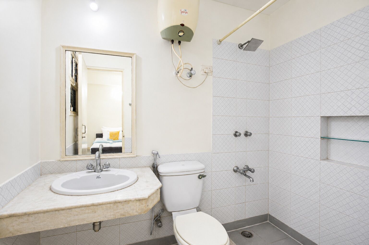 A bathroom with a sink, toilet, and shower.