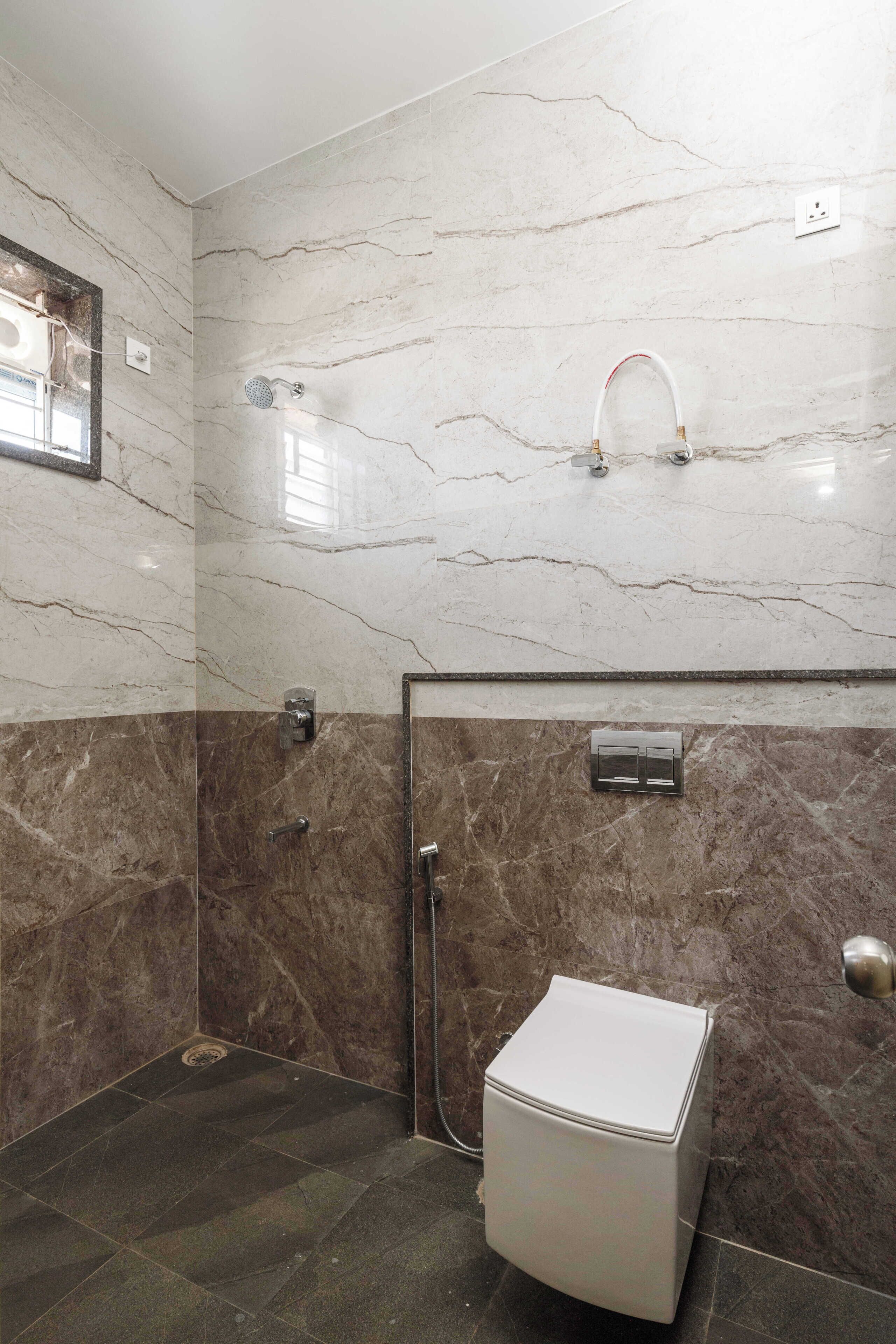 A bathroom with a shower, toilet, and a mirror.