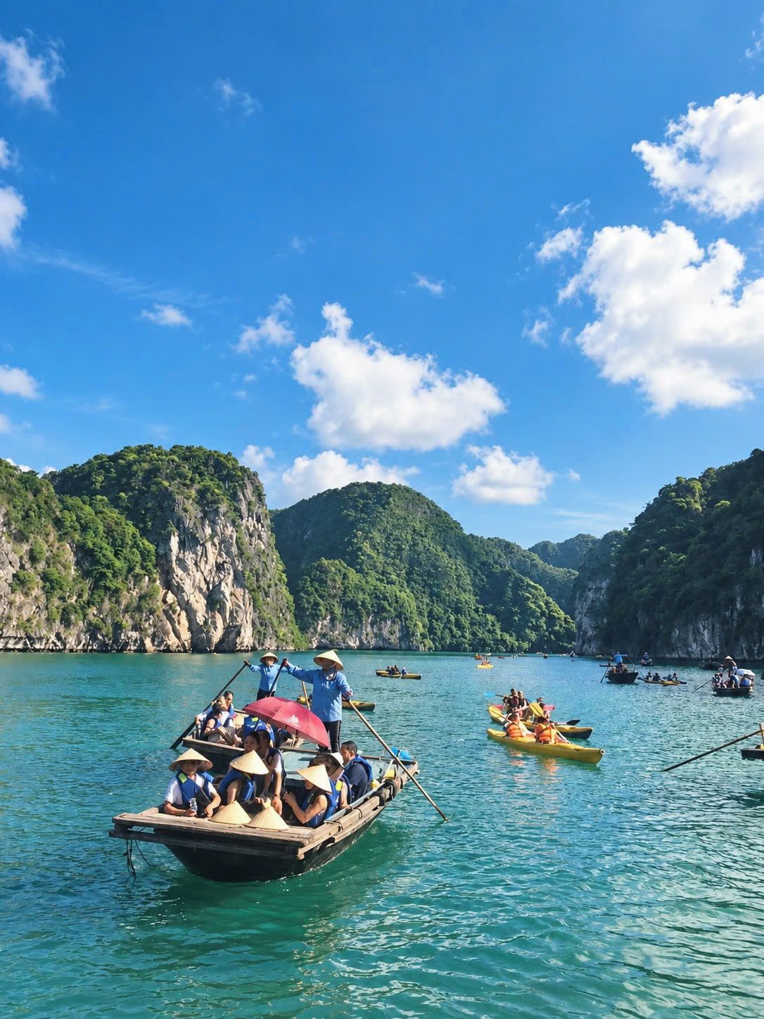A group of boats on a calm body of water surrounded by lush green hills.