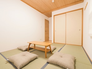 A room with tatami mats, a low wooden table, and a sliding door. - Chayaju (Osaka)