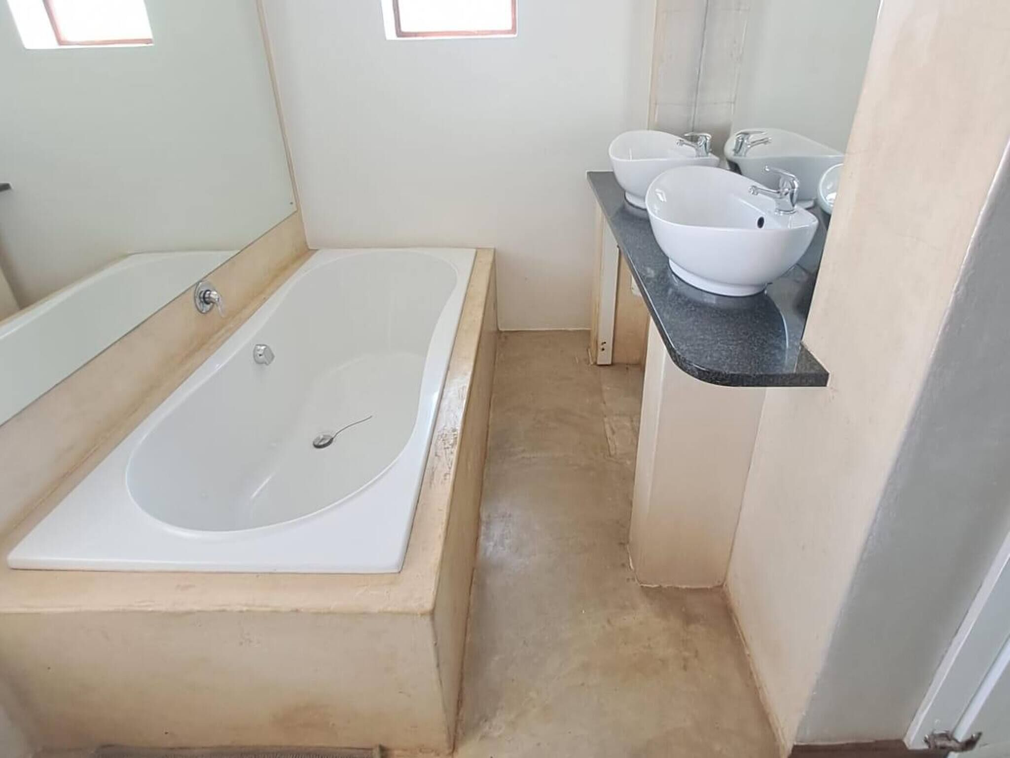 A bathroom with a bathtub, a sink, and a countertop.