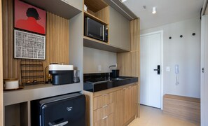 A compact kitchen with a microwave, coffee maker, and a refrigerator. - Beautiful Comfort 800m From the Metro Oag0505 (São Paulo)