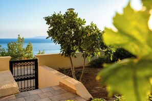 A balcony with a view of the sea, a gate, and a tree. - Tasos By the Sea (Rhodes)