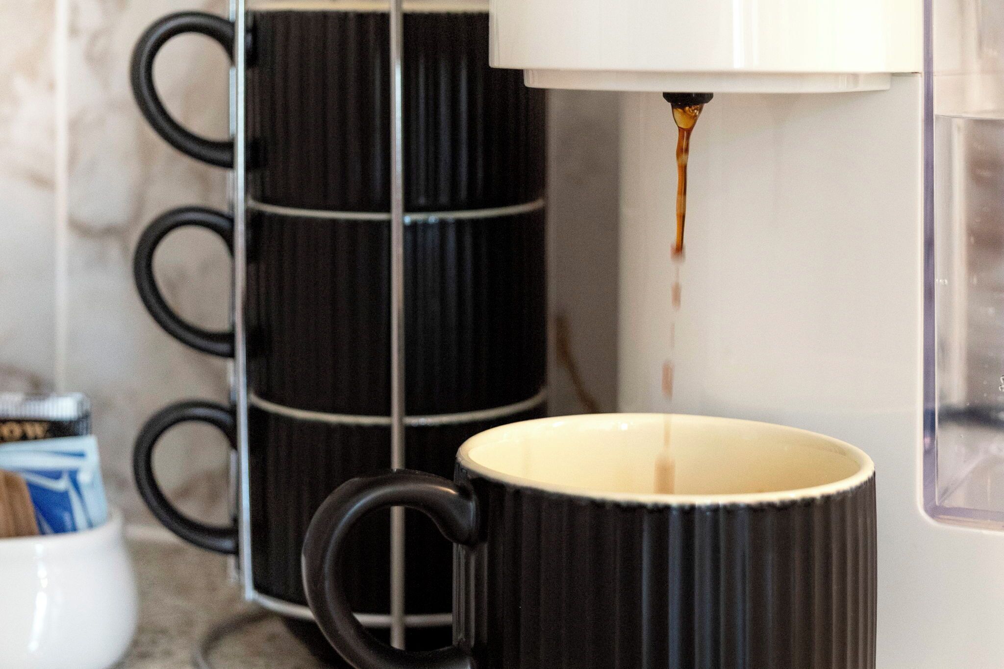 A coffee machine dispensing coffee into a mug.