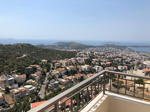 A residential area with buildings, roads, and a coastline. - Casa Panorama in Voula - Panoramic Sea View Villa (Vari-Voula-Vouliagmeni)