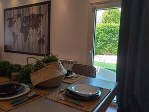 A dining table set with plates, cutlery, and a woven basket. - Casa Panorama in Voula - Panoramic Sea View Villa (Vari-Voula-Vouliagmeni)