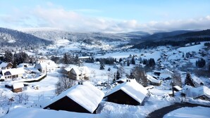 A snow-covered village with traditional houses and a clear sky.