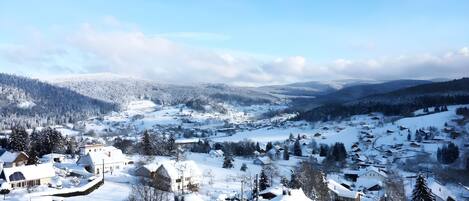 A snow-covered village with traditional houses and a clear sky.
