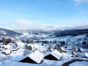 A snow-covered village with traditional houses and a clear sky.
