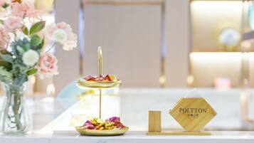 A table with a tiered serving dish, a small bowl, and a wooden sign with text.