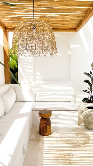 A modern interior with a white sofa, a wooden side table, and a hanging woven light fixture. - Designer 2BR Private Pool Villa Near Nyang Nyang Beach Uluwatu (kuta selatan)