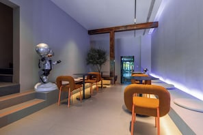 A modern interior with a robot figure, wooden furniture, and a large window.