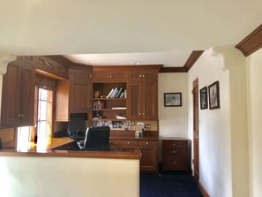 A kitchen with wooden cabinets, a countertop, and a computer. - Grand Craftsman Estate built in 1937 Charms in the heart of Carmel By The Sea (Carmel)