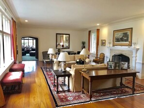 A traditional living room with a fireplace, a sofa set, a coffee table, and a rug. - Grand Craftsman Estate built in 1937 Charms in the heart of Carmel By The Sea (Carmel)