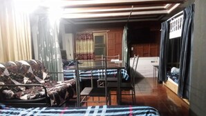 A room with a bed, a desk, and a chair. There is a window with curtains, and a door leading to another room. - Room-charming Family Guest Room for 6 gu (Pattaya)