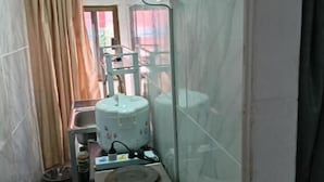 A narrow kitchen with a gas stove, a small sink, and a window with curtains. - Room-charming Family Guest Room for 6 gu (Pattaya)