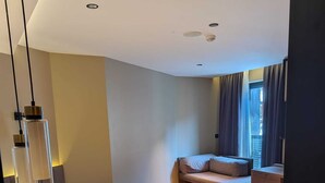 A modern bedroom with a bed, bedside table, and a window with curtains. - Tanyel Hotel (Istanbul)